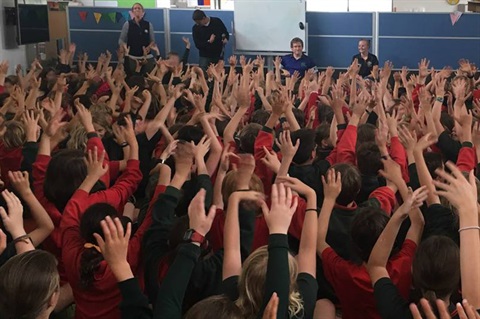 Schoolkids-with-hands-raised.jpg
