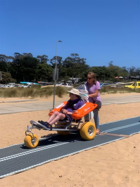 Beach wheelchair in use on the access matting at Fishermans Beach Torquay