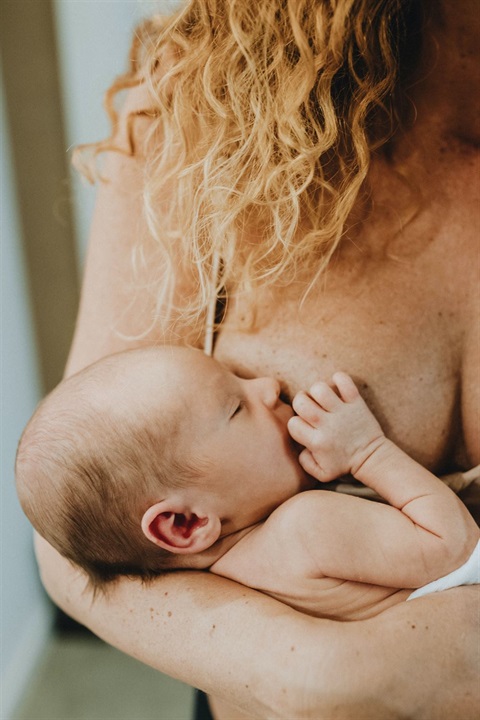 parent with red hair breastfeeding newborn baby.jpg