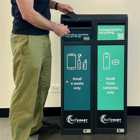 person putting mobile phone into collection bin